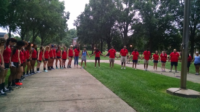 Orientation staff and volunteers gathered around Erskine's flagpole on Move In Day morning to pray for Orientation.